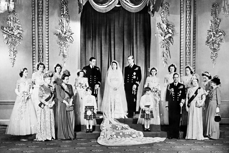 Members of the British Royal family and guests pose around Princess Elizabeth (future Queen Elizabeth II) (CL) and Philip, Duke of Edinburgh (CR) (future Prince Philip); at right the group includes Britain's King George VI (5R) stood next to Queen Elizabeth (3R) with Princess Alice of Athlone (R) and in front of bridemaids that include Princess Margaretb (7R) stood next to Philip; at left the group includes the best man David Mountbatten, Marquess of Milford Haven (7L) stood next to Princess Elizabeth, Mary of Teck (3L), mother of King George VI, stands at left in front of the bridesmaids next to Princess Alice of Battenberg (5L), Philip's mother; the page boys are Prince William of Gloucester and Prince Michael of Kent; in the Throne Room at Buckingham Palace on their wedding day November 20, 1947. (Photo by STR and - / AFP) (Photo by STR/AFP via Getty Images)
