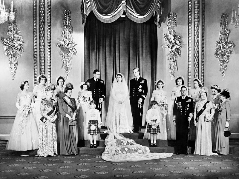 Members of the British Royal family and guests pose around Princess Elizabeth (future Queen Elizabeth II) (CL) and Philip, Duke of Edinburgh (CR) (future Prince Philip); at right the group includes Britain's King George VI (5R) stood next to Queen Elizabeth (3R) with Princess Alice of Athlone (R) and in front of bridemaids that include Princess Margaretb (7R) stood next to Philip; at left the group includes the best man David Mountbatten, Marquess of Milford Haven (7L) stood next to Princess Elizabeth, Mary of Teck (3L), mother of King George VI, stands at left in front of the bridesmaids next to Princess Alice of Battenberg (5L), Philip's mother; the page boys are Prince William of Gloucester and Prince Michael of Kent; in the Throne Room at Buckingham Palace on their wedding day November 20, 1947. (Photo by STR and - / AFP) (Photo by STR/AFP via Getty Images)