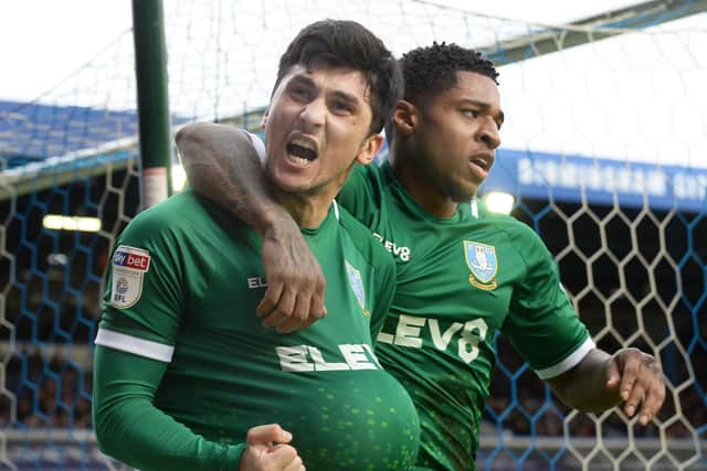Sheffield Wednesday's Fernando Forestieri celebrates his penalty goal with the ball up his shirt with team-mate Kadeem Harris. Pic Steve Ellis
