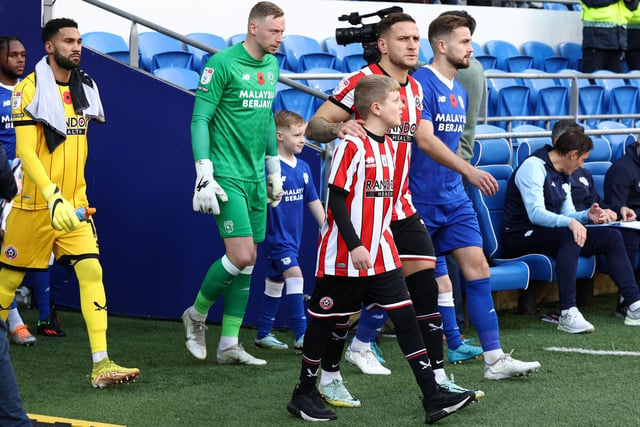 Skipper Sharp walks out with the Blades mascot ahead of the game