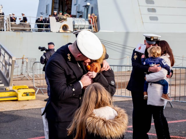 Families embracing their loved ones as soon as they step off HMS Defender. Picture: Habibur Rahman