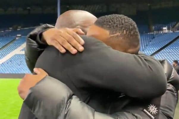 Sheffield Wednesday boss Darren Moore is embraced by former Owls striker Clinton Morrison after their historic play-off win over Peterborough United.