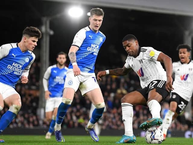 LONDON, ENGLAND - FEBRUARY 23: Ivan Cavaleiro of Fulham battles for possession with Josh Knight of Peterborough United during the Sky Bet Championship match between Fulham and Peterborough United at Craven Cottage on February 23, 2022 in London, England. (Photo by Alex Davidson/Getty Images)