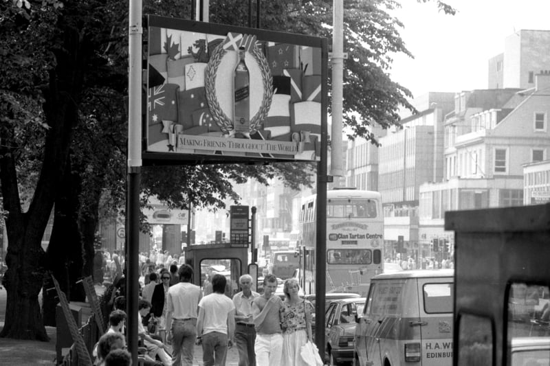 The Commonwealth Games 1986 sponsored signs go up in Princes Street Edinburgh, June 1986 - this sign reads: Making Friends Throughout the World and is sponsored by Johnny Walker whisky.