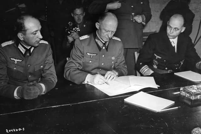 German military ledaders sign the document of surrender in 1945