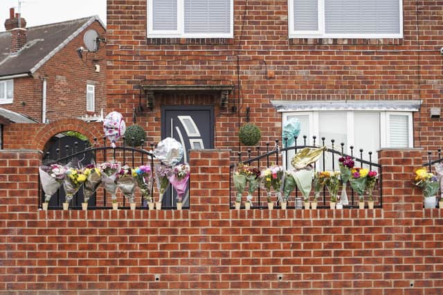 Floral tributes have been left at the house where a woman was killed in a tragic dog attack in Rotherham. Picture by Scott Merrylees