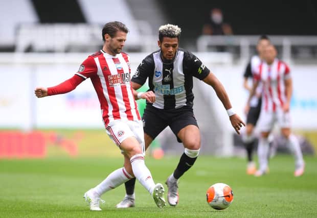Ollie Norwood of Sheffield United shoots battles with Joelinton of Newcastle United during the Premier League match between Newcastle United and Sheffield United at St. James Park. (Photo by Laurence Griffiths/Getty Images)