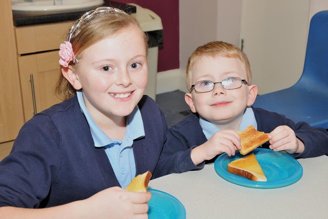 Owton Manor Primary School pupils Nicole Gray (11) and Curtis Morfoot (5) enjoying their toast at the breakfast club.