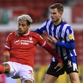 Sheffield Wednesday defender Joost van Aken muscles for a ball with Nottingham Forest's Lyle Taylor.