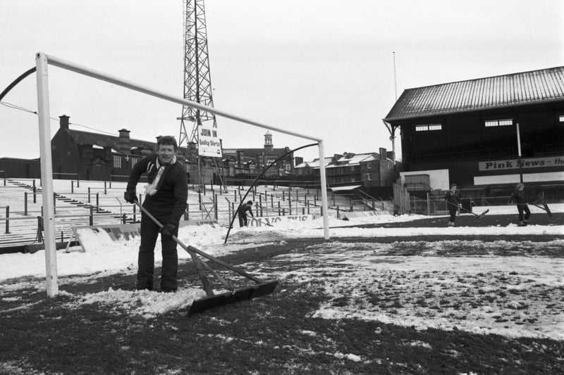 Hearts football club's player-manager Alex Macdonald clears snow from the pitch at Tynecastle in January 1984.