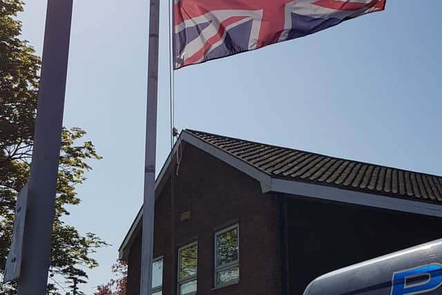 A flag flying at half-mast in honour of a South Yorkshire police officer who died in a collision in Sheffield yesterday