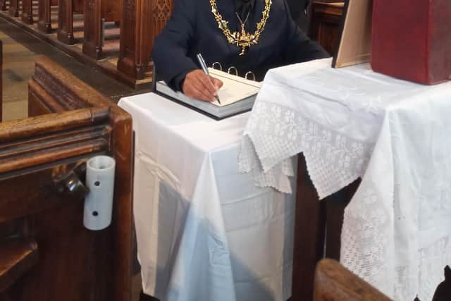 Councillor Tajamal Khan, Mayor of Rotherham, signed the book of condolences at Rotherham Minster this morning.