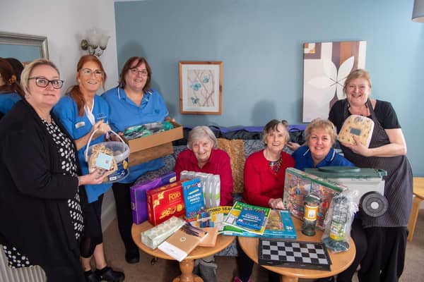 Staff and residents from Brailsford House Care Home receiving their care package