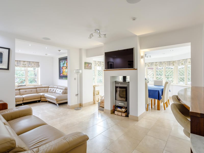 The open plan living area is a perfect family room and has a feature wood burner