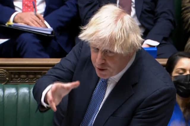 Prime Minister Boris Johnson speaking during Prime Minister's Questions (PMQs), in the House of Commons in London on December 8, 2021. PRU/AFP via Getty Images.