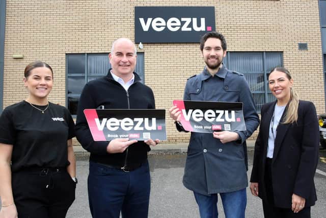 Team members from Veezu and Shawmind outside their office