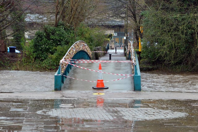 Bridges are closed to pedestrians as water threatens to breach the banks.
