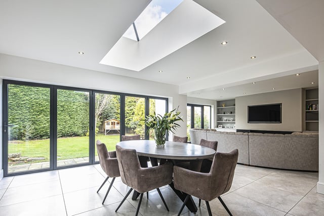 The entire space stretches across the rear of the property, with the skylights and near floor-to-ceiling windows allowing floods of natural daylight in.