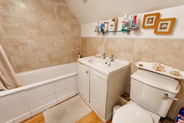 The bathroom suite includes a wash basin with vanity unit.