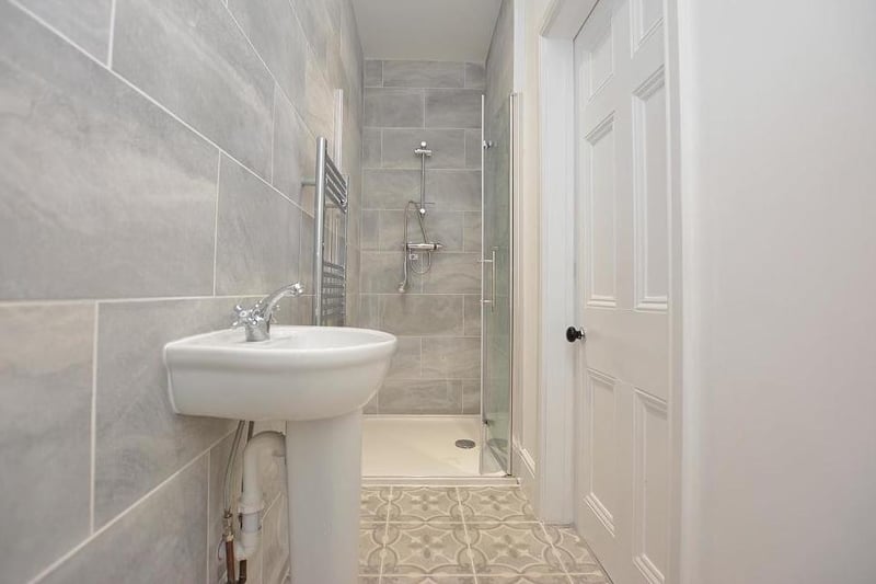 The first of two en-suite shower rooms, complete with a modern three-piece suite, comprising walk-in shower, wash hand-basin and low-flush WC. There is also a heated towel-rail, ceiling spotlights, tiled floor and extractor fan.