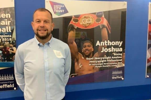 Simon Coates with portrait of Anthony Joshua in the Hall of Champions at the English Institute of Sport Sheffield.