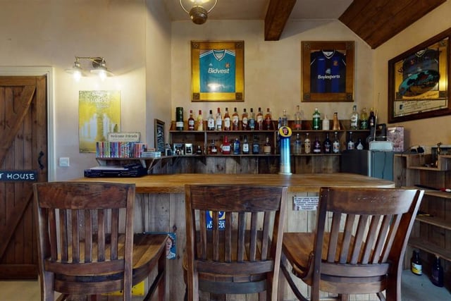 The former double garage has been converted into a home bar, providing an ideal space to entertain.