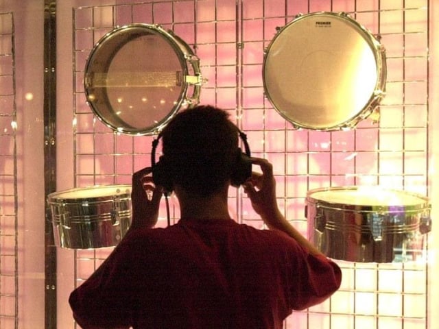 A young visitor looks and listens on the last day of opening in 2000.