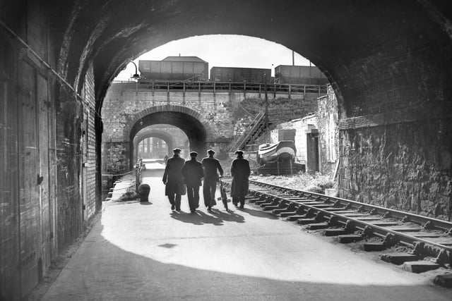 Four  Wearside workmen passing through one of railway arches that were a feature of the west side of the South Docks in 1950.