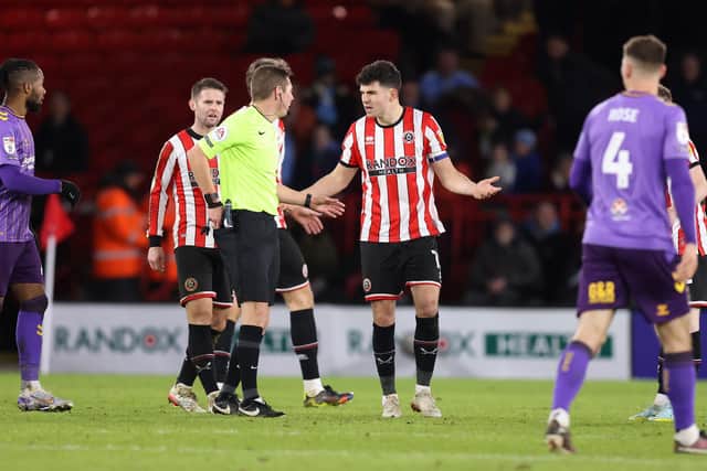 John Egan of Sheffield United reacts after being shown a red card by referee Matt Donohue against Coventry City (George Wood/Getty Images)