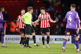 John Egan of Sheffield United reacts after being shown a red card by referee Matt Donohue against Coventry City (George Wood/Getty Images)