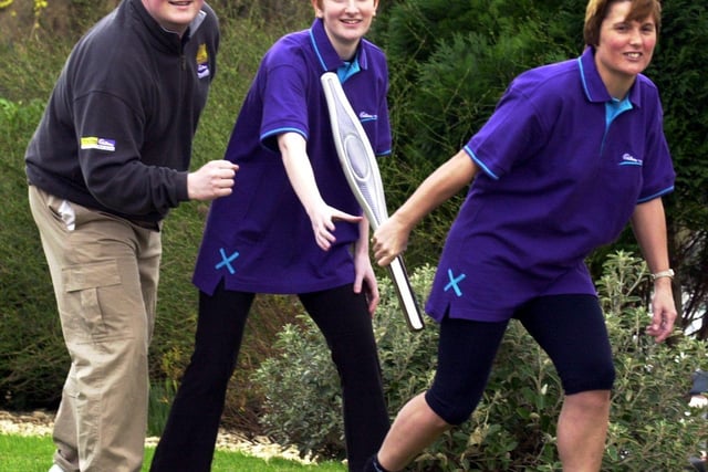 Bassetts employees, Lee Birmingham, Katie Thompson and Sandra McDonald with the Queen's Jubilee Baton they carried as part of the relay to celebrate the Golden Jubilee
in March 2002