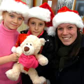 Alix Billing (8), left, Demi Scarborough (10) and Tessa Harrison try to guess the name of the bear at the Christmas Market at Margetson Crescent, Parson Cross, Sheffield on December 12, 2009