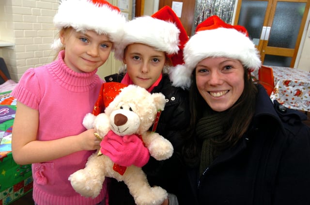 Alix Billing (8), left, Demi Scarborough (10) and Tessa Harrison try to guess the name of the bear at the Christmas Market at Margetson Crescent, Parson Cross, Sheffield on December 12, 2009