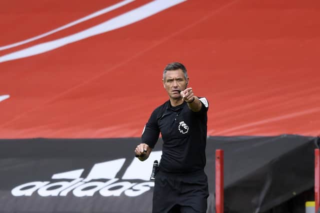 Referee Andre Marriner gives directions during the English Premier League soccer match between Sheffield United and Fulham at Bramall Lane stadium in Sheffield. (Gareth Copley/Pool via AP)
