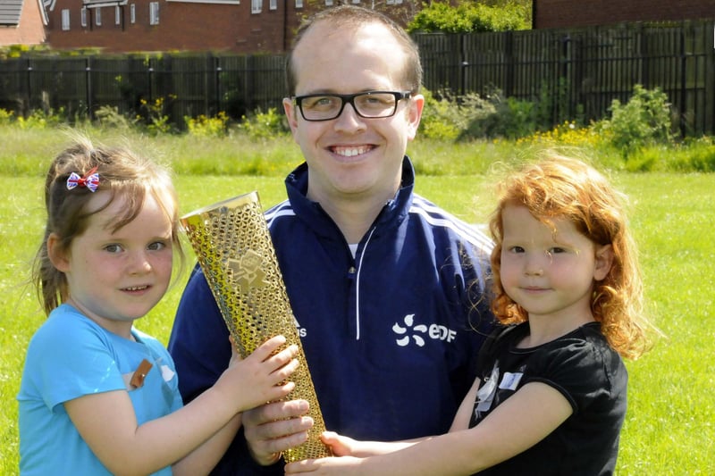 Lucie Willis and Anna Hope at Mill Hill Primary School. They are pictured with Olympic torch bearer Gareth Capstick during the school sports day in 2019.