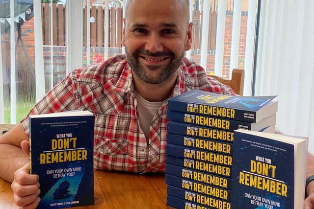 Former teacher Steve Johnson at home in Rotherham with physical copies of his co-authored debut novel.