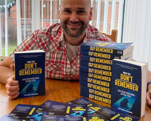 Former teacher Steve Johnson at home in Rotherham with physical copies of his co-authored debut novel.