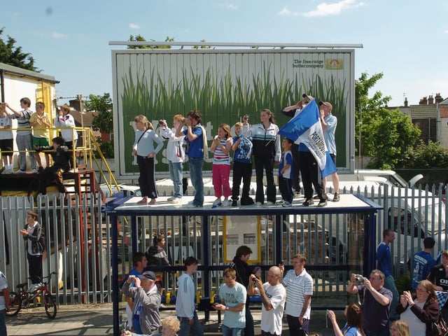 Even the bus stop is used to gain a better view of the celebrations. Picture: Malcolm Wells 082235-59