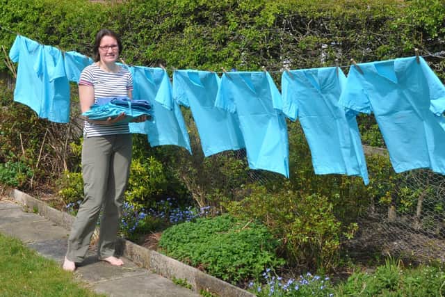 Volunteer stitcher Rebecca Hammond, who is among a network of dozens of home sewers who are appealing for cash for fabric as they race to fulfil hundreds of requests for clinical scrubs. Photo: Graeme Hammond/PA Wire