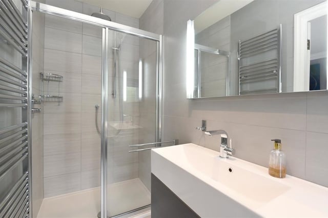 Definitely smaller than the master en-suite, but more than makes up for it by appearance, this en-suite looks stunning and is perfect for making those final adjustments in the morning with the lights at the side of the mirror.
