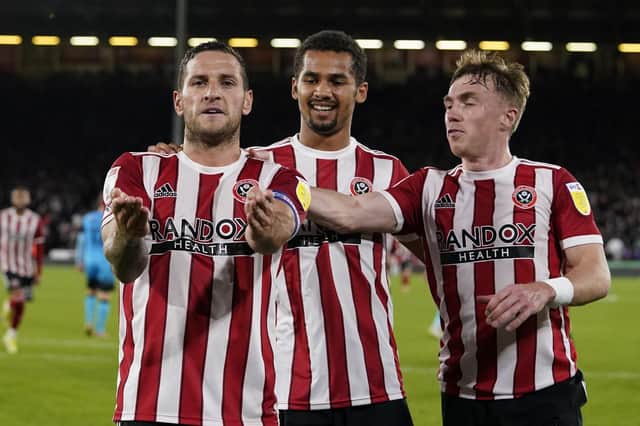 Billy Sharp of Sheffield United (L) celebrates after scoring from the penalty spot with lliman Ndiaye and Ben Osborn: Andrew Yates / Sportimage