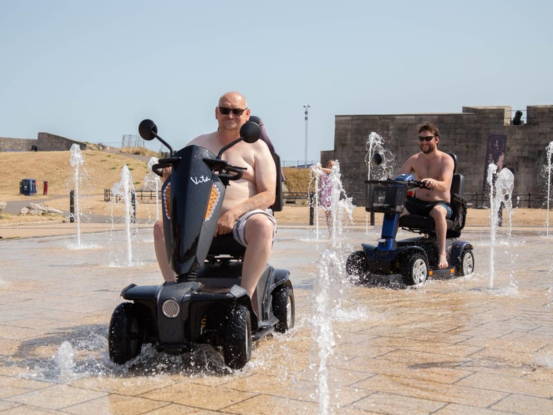 The fountains near Southsea Castle on Brian Kidd Way are a magnet for people wanting to cool off. Here are John Millington and Shane Davis in 2022