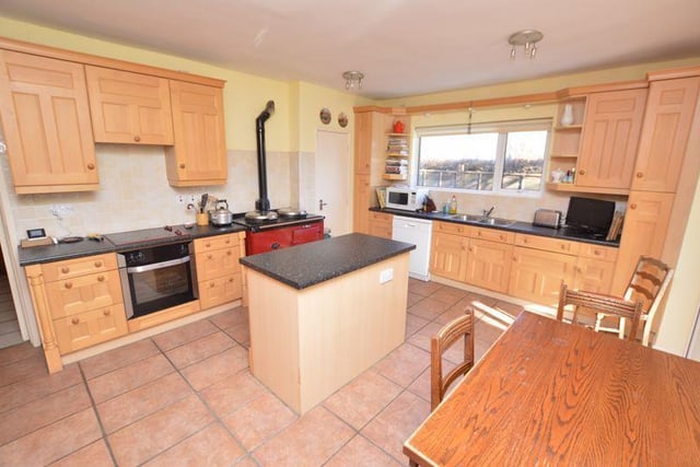 The large kitchen has a range of appliances and plenty of storage space.