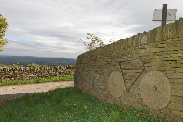 A dry stone wall erected for the Tour de France, cleverly using Sheffield grindstones as wheels