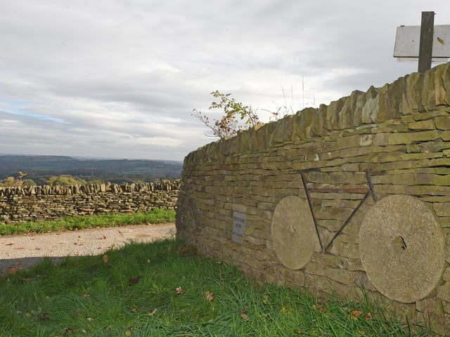 A dry stone wall erected for the Tour de France, cleverly using Sheffield grindstones as wheels