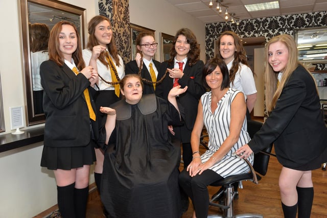 Isobel Joyce is with stylist Tracy Lancaster from Liberty Hair Salon half way through her charity haircut five years ago. She is pictured with her school friends Eve Readman, Katie Priest, Beth Causation, Hannah Snowdon, Jen Foreman and Olivia Bennison.