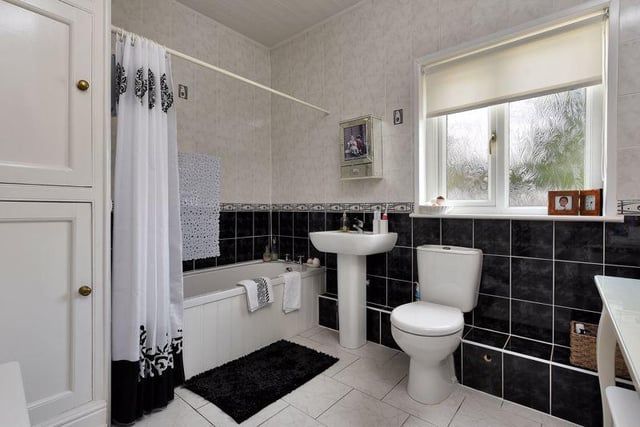 Inside one of the home's four bathrooms, which is tastefully finished in black and white.