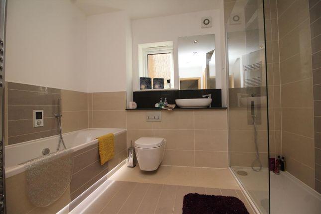 The main bathroom comprises a bath, a separate shower cubical plus basin and unit, with mood lighting and tiled walls.