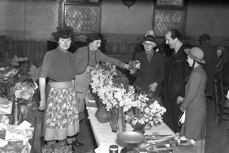 Admiring the spring flowers on a stall at Sunderland's Women's Conservative Association bring and buy sale in April 1945.