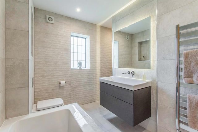 Family Bathroom - Luxuriously appointed and fitted with a WC, a wash hand basin with large vanity unit and mixer tap and a double ended bath with mixer tap and shower attachment. There is a wet area with shower, tiling to the walls and floor and a chrome heated towel rail.